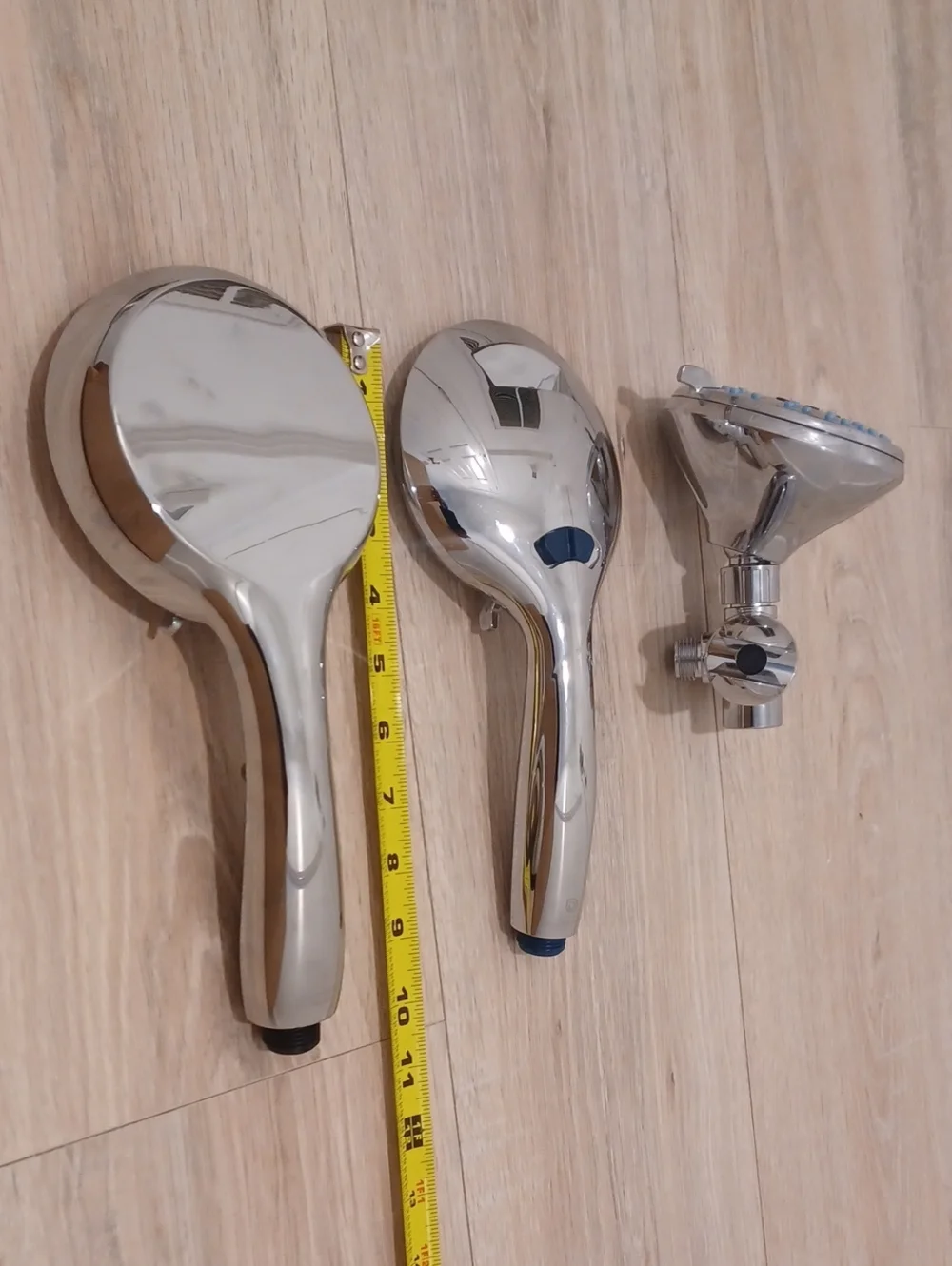 Bundle of chrome shower heads with flexible hose. Bath. Hand held.